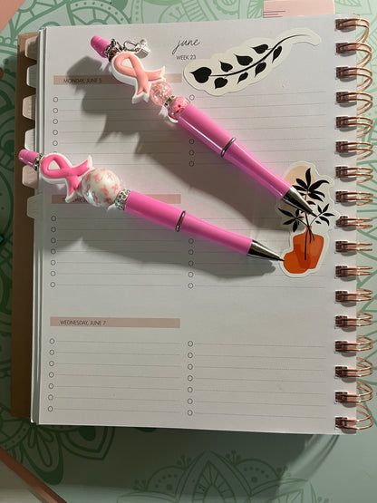 Cancer Awareness Pink Ribbon Bling Pens on top of planner