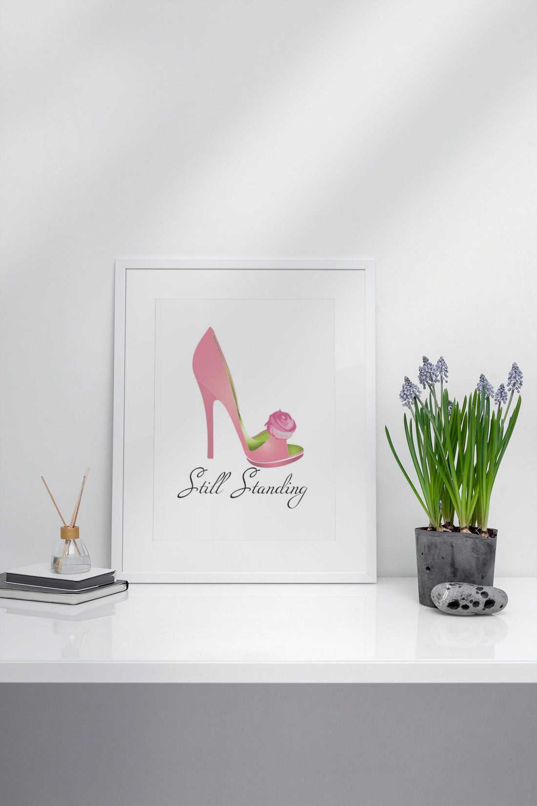 AKA Still Standing Pink and Green Shoe Art Print on Desk with Plant and Decor